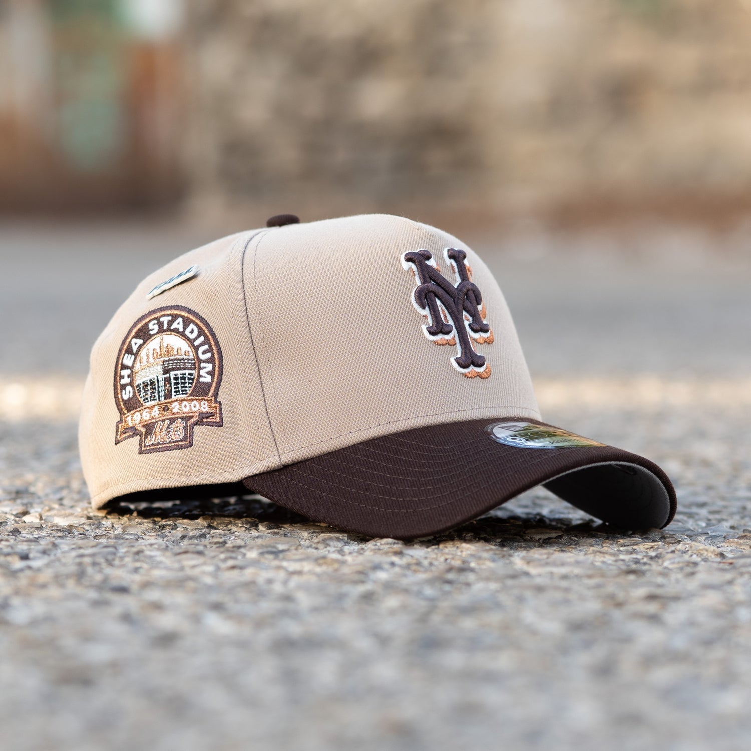 Beige and brown baseball cap with logo on a blurred background